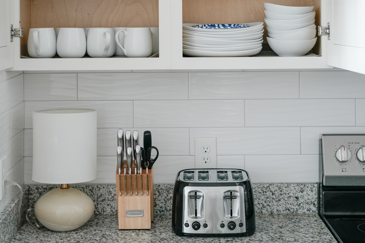 Fully equipped kitchen with a convenient toaster, knife block, and dishware for easy everyday meals.