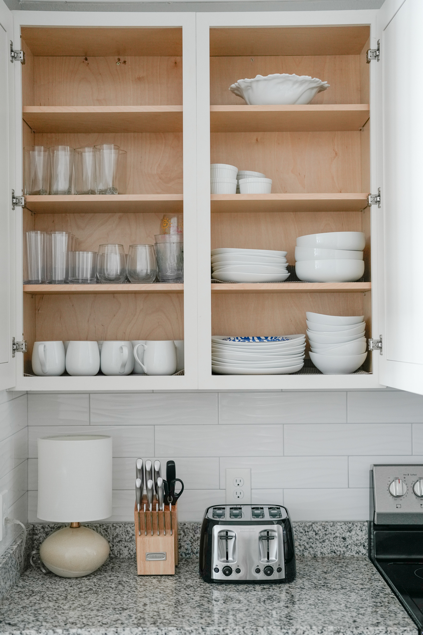 Fully equipped kitchen with a convenient toaster, knife block, and dishware for easy everyday meals.