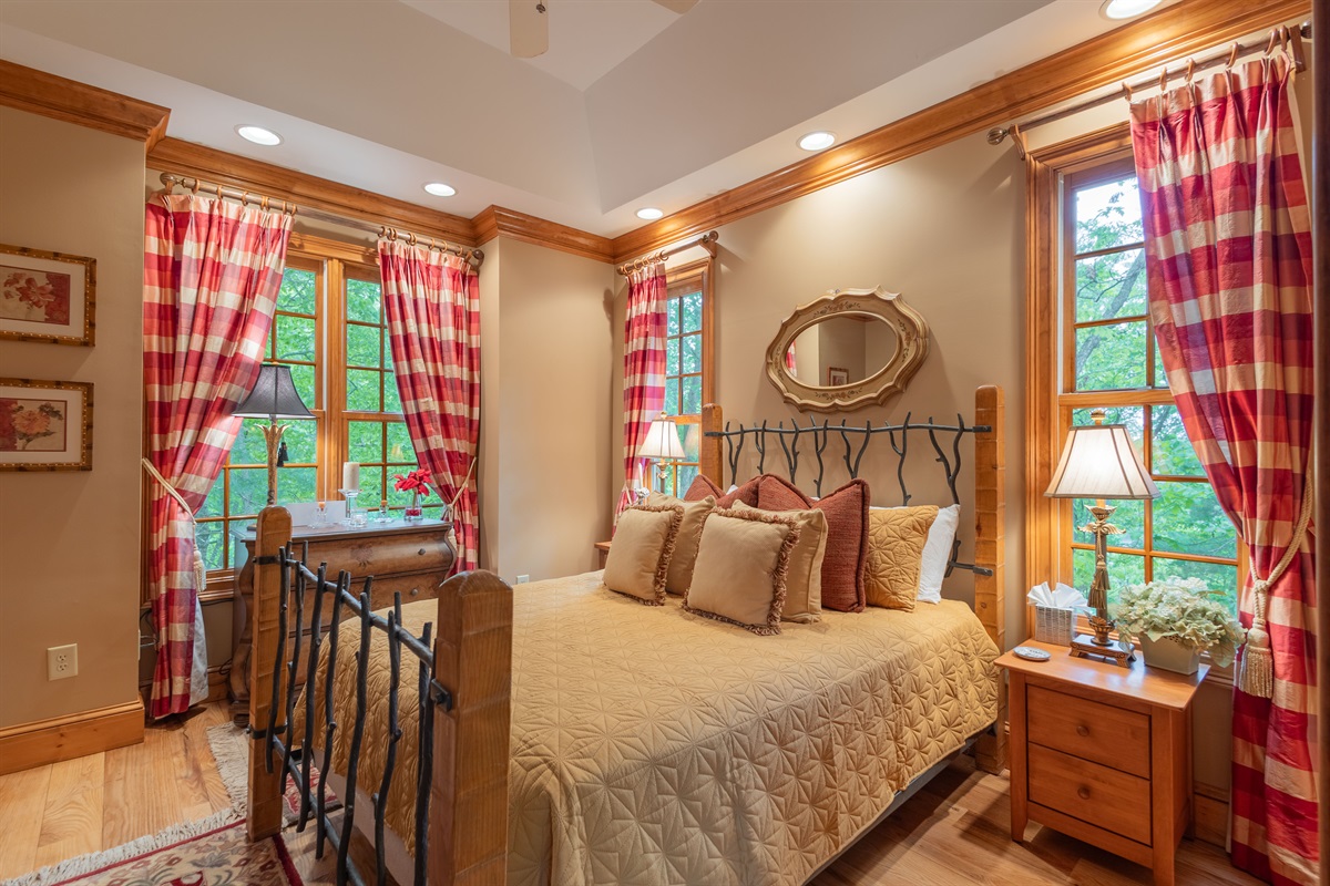 Natural light, charming mountain décor, and peaceful wooded views make this bedroom the perfect place to relax and recharge after a day exploring the mountains.