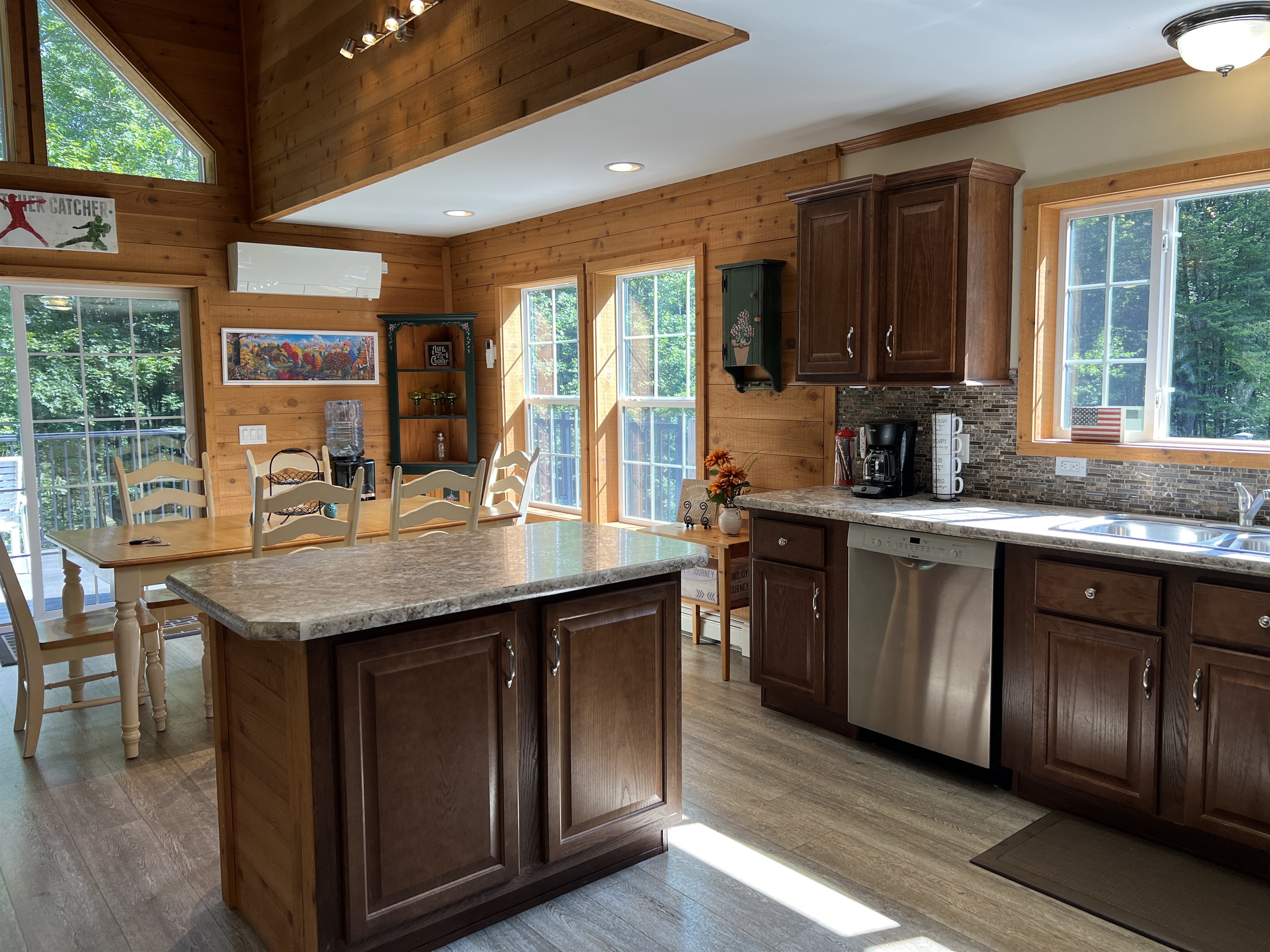 Kitchen into dining area with sliders to deck beyond