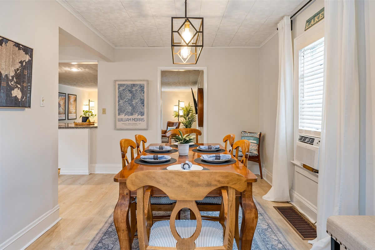 Open-concept dining area seamlessly connects to the cozy living space, ideal for both intimate dinners and lively group gatherings. Seats 6 with an extra leaf and additional bench seating