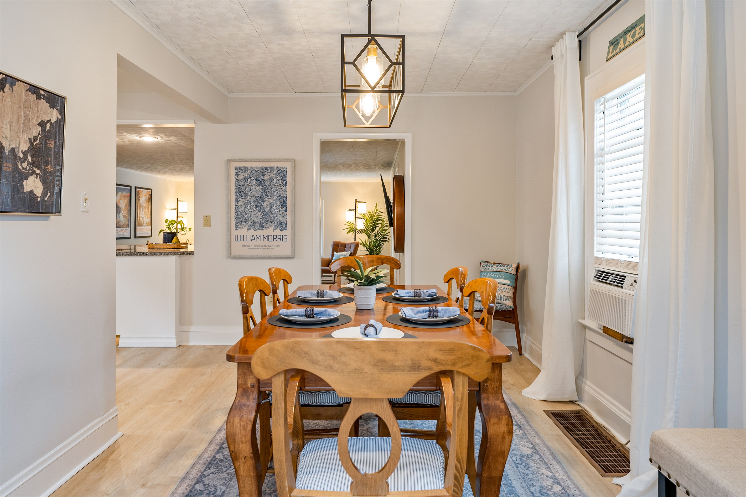 Open-concept dining area seamlessly connects to the cozy living space, ideal for both intimate dinners and lively group gatherings. Seats 6 with an extra leaf and additional bench seating