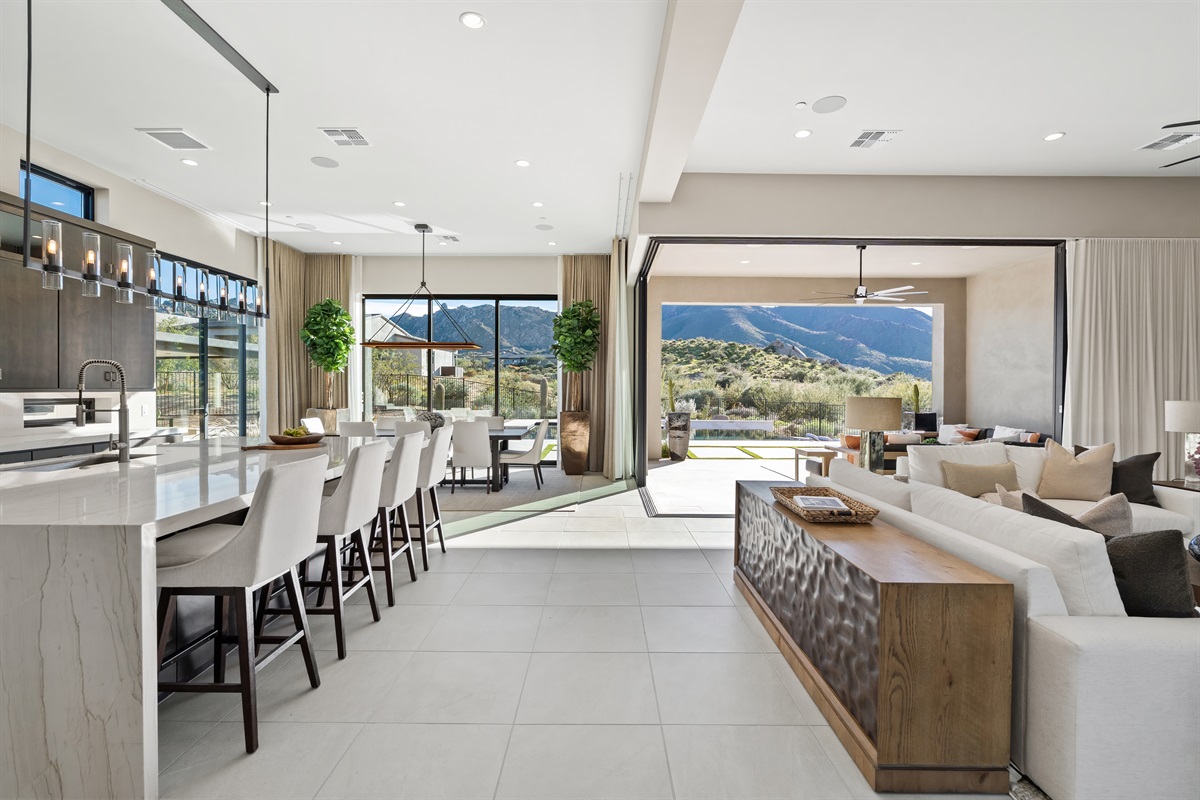Open-concept luxury retreat with mountain views, seamless indoor-outdoor living, and a sleek modern kitchen.