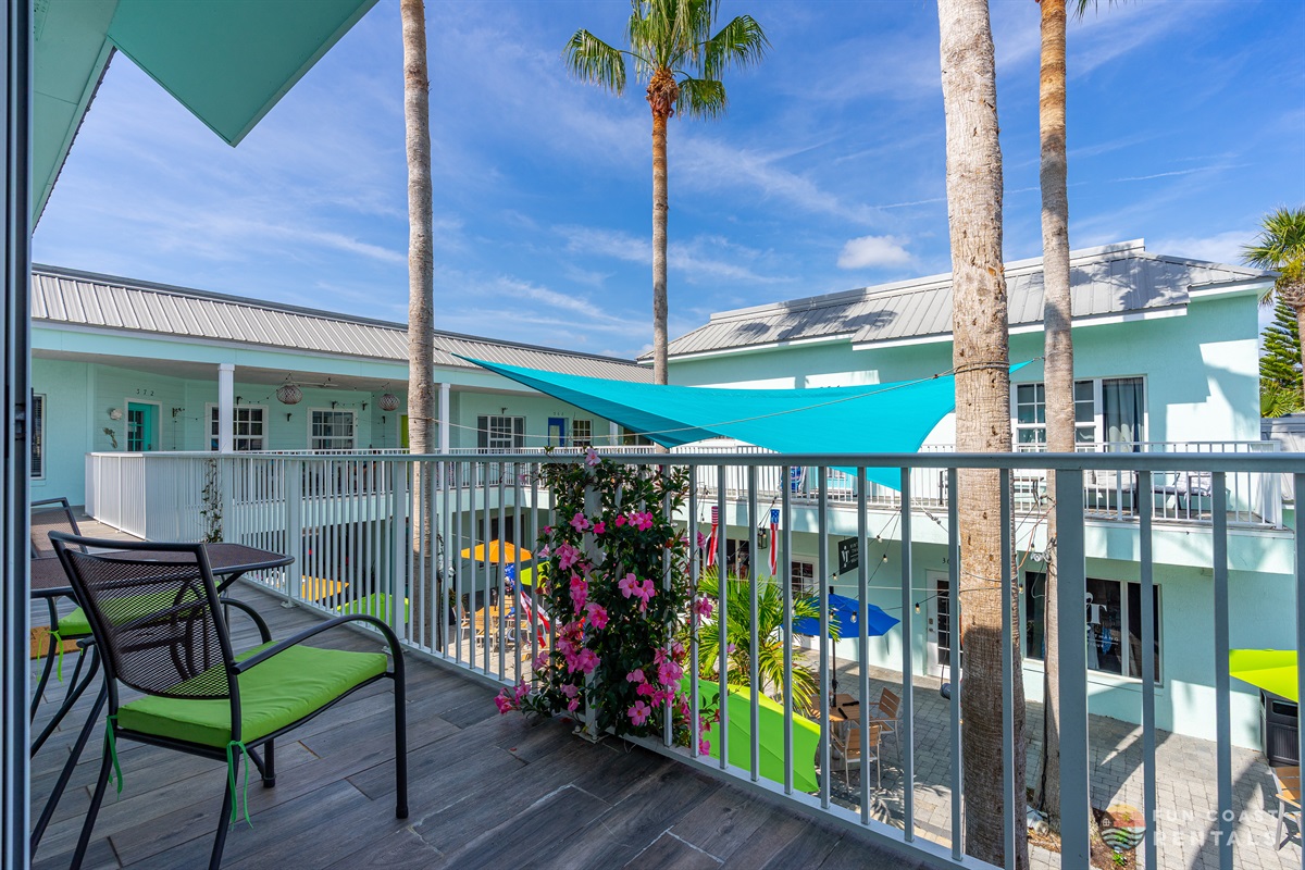 Quaint balcony overlooking community courtyard with shops and restaurants!