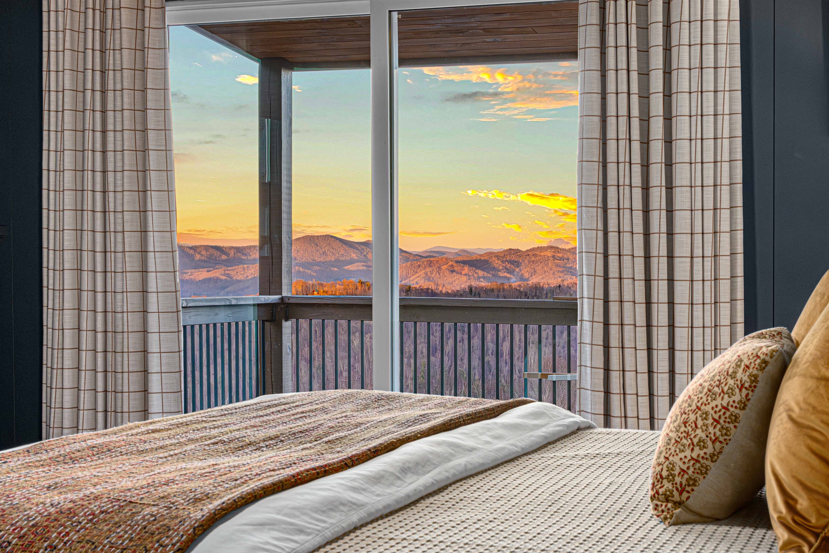 Wake up to mountain views from the Bear Room’s glass sliding door, which opens directly to a covered porch with comfortable seating—perfect for morning coffee or a quiet evening unwind.