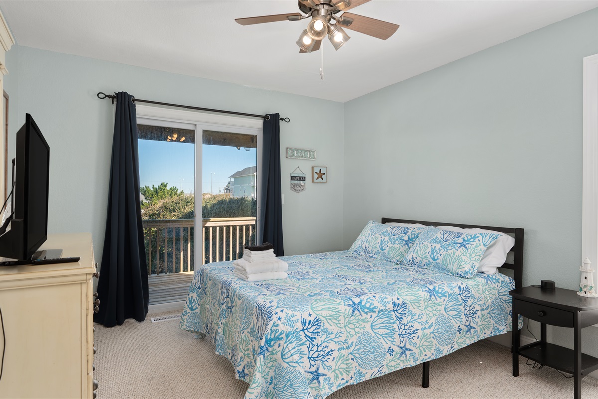 Bright Queen room with sliding door to private deck.