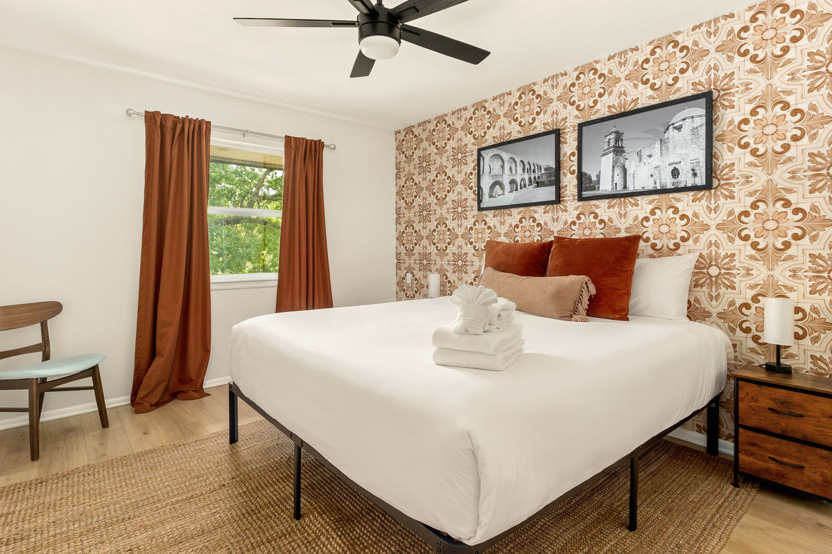Wake up refreshed in this beautifully designed bedroom with natural light and cozy furnishings.