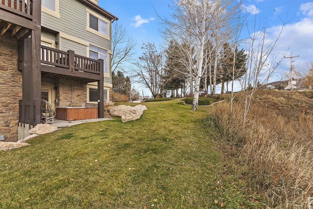 A backyard area with easy access to the patio, offering additional outdoor space for relaxation and enjoyment.