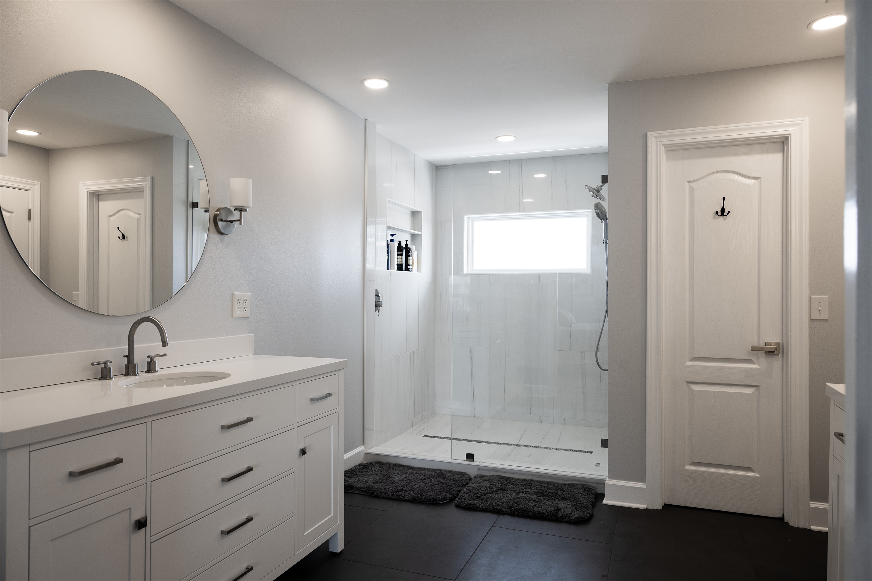 Primary Suite Bath with walk-in closet, double vanities and luxury shower with Lagoon views