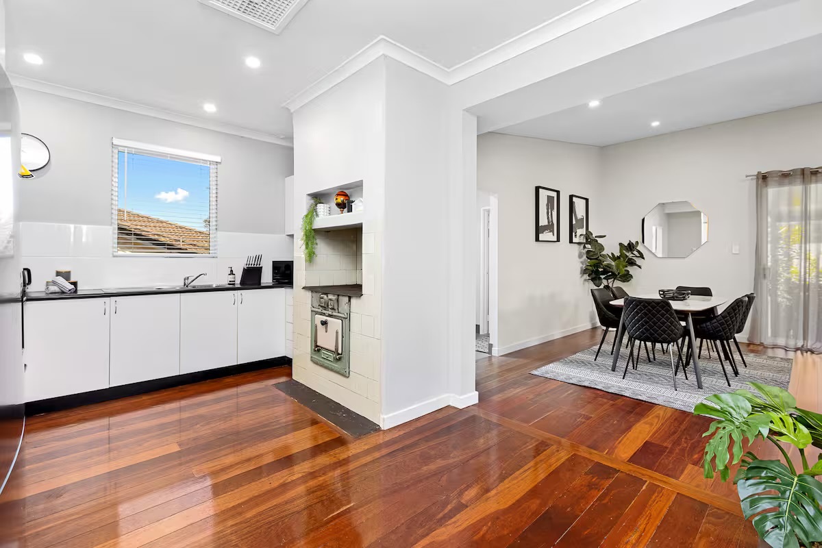 The open-plan kitchen connects bench space, cooking appliances and everyday essentials in one practical zone at Sasha’s Cottage on the Hill.