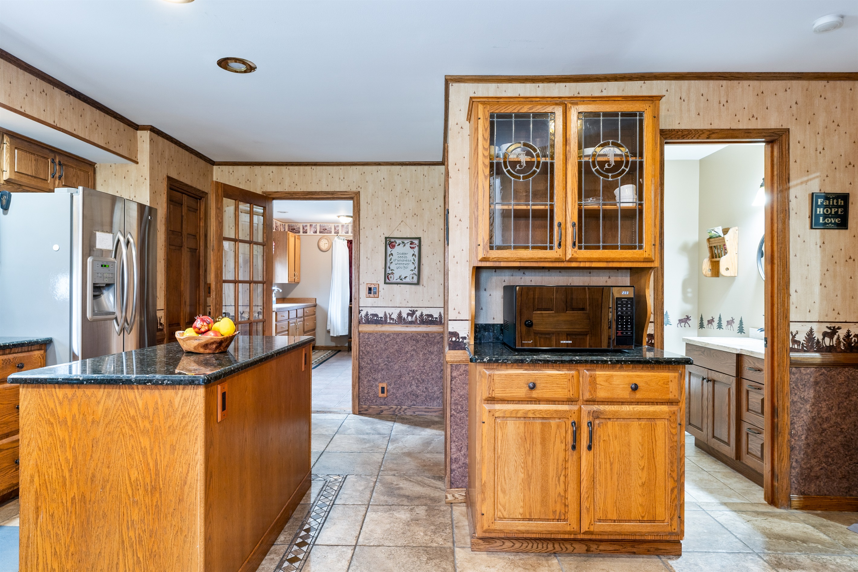 Warm and inviting kitchen featuring stainless steel appliances and open shelving for a modern country feel