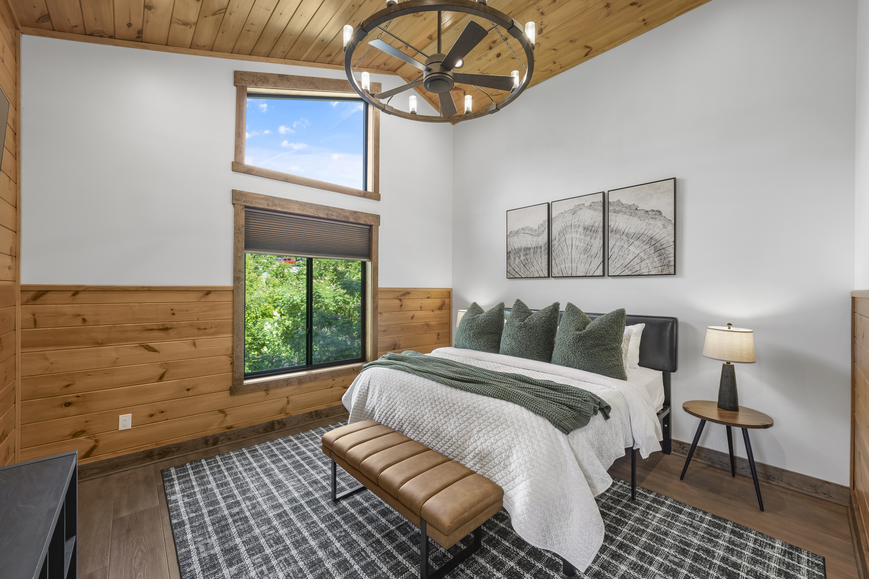 King Suite with vaulted ceilings an x-large TV. Unwind in the en-suite bathroom featuring a luxurious walk-in shower with a natural river rock floor, bringing  the Smoky Mountains indoors for a spa retreat.