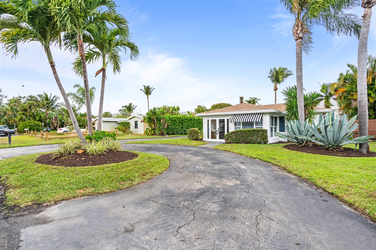 Tucked beneath swaying palms, this inviting coastal home offers privacy, sunshine, and laid-back luxury.