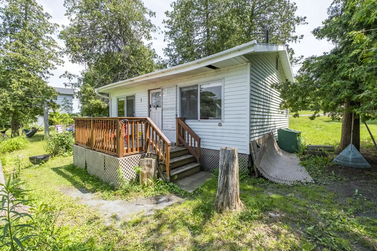 Front entrance of Cottage #1 surrounded by mature trees
