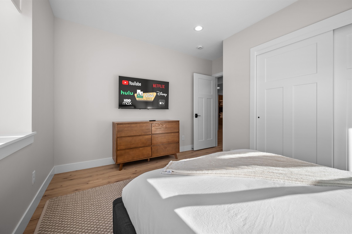 Spacious Queen Bedroom with Smart TV — perfect for winding down.