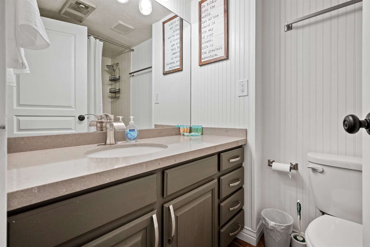 Clean, modern bathroom with ample counter space and bright lighting.
