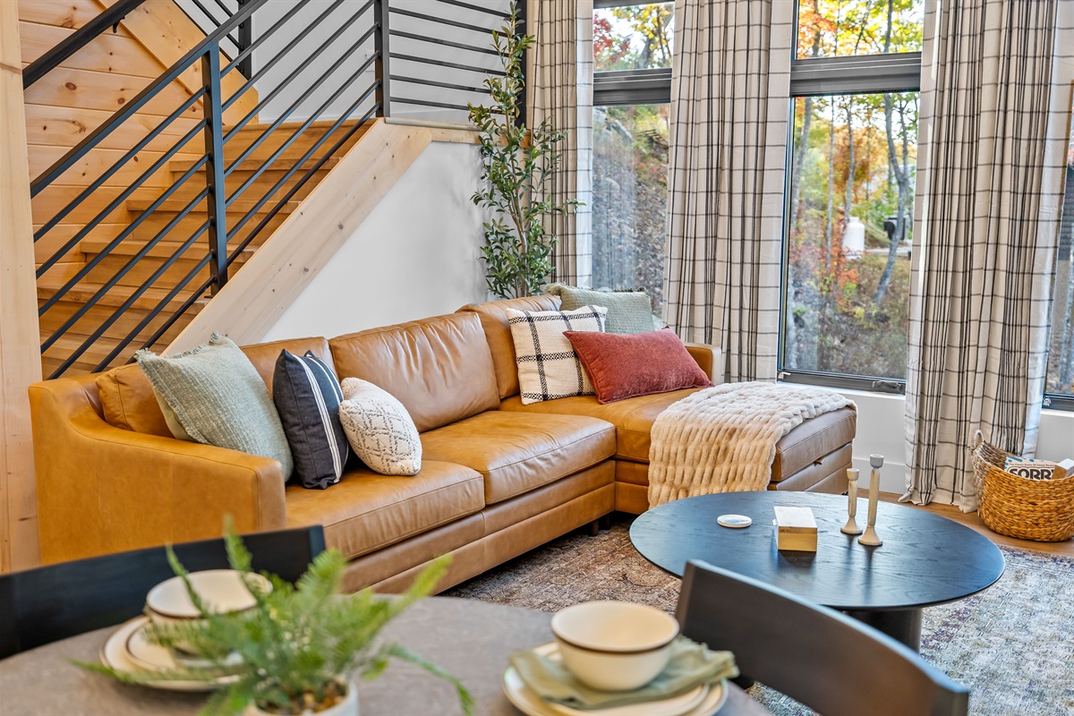 Bright, modern living room with peaceful forest views