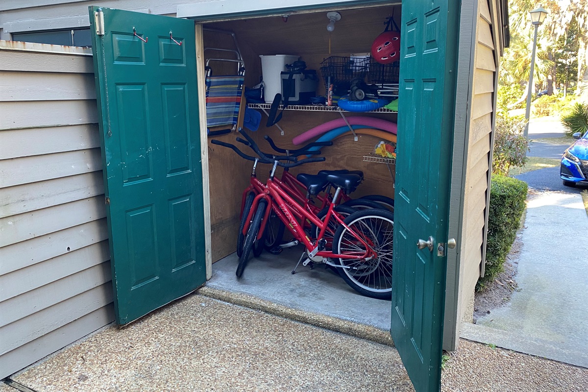 Porch with 4 bikes and pool items and wagon
