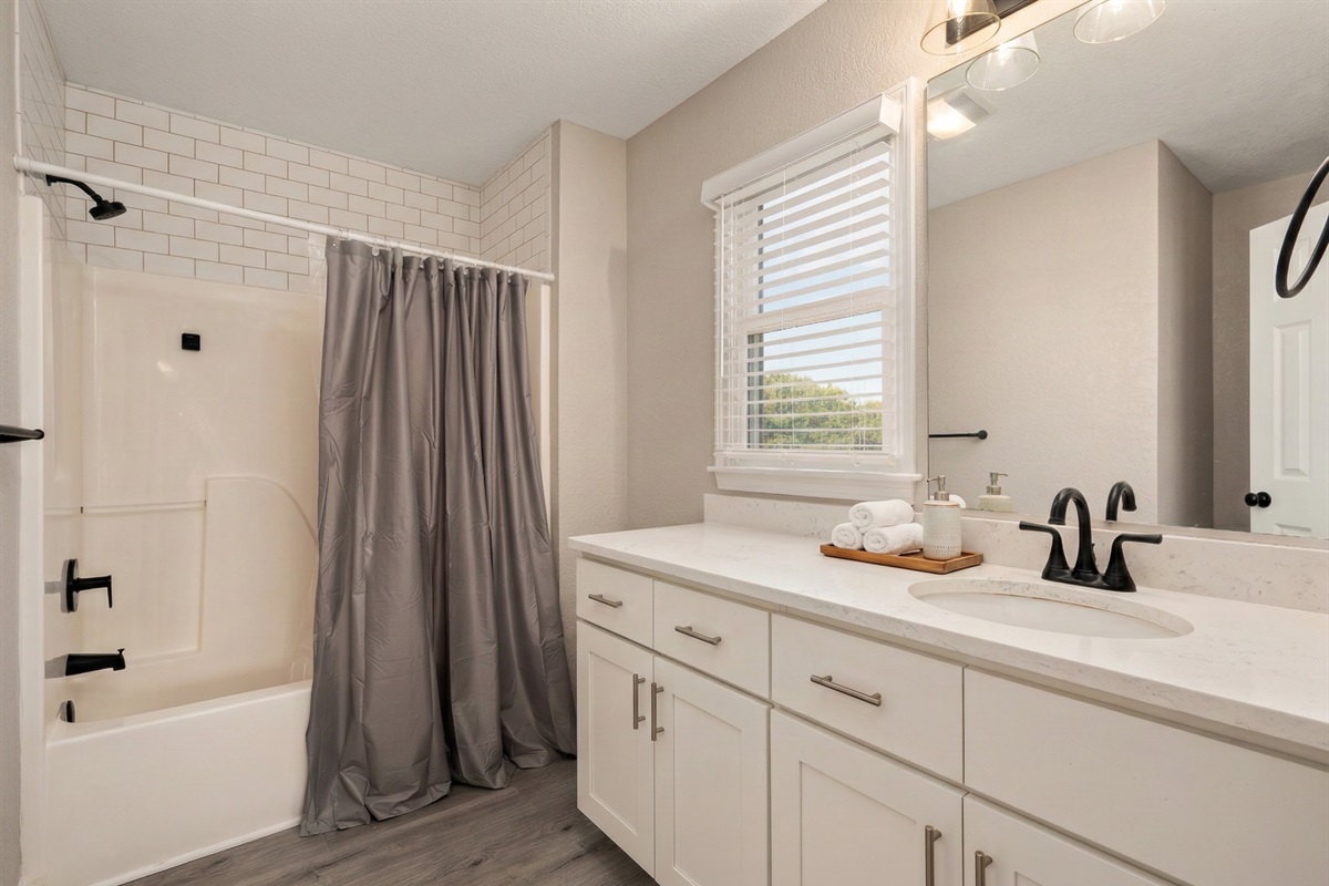 ML Bedroom 5 Bath - Bright and modern bathroom featuring a tub-shower combo and contemporary finishes.