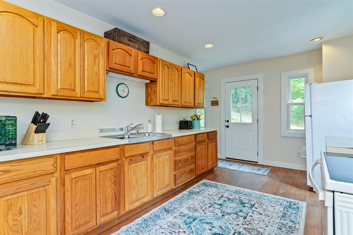 Spacious galley kitchen featuring ample counter space, updated appliances, and plenty of storage, ideal for cooking and entertaining.