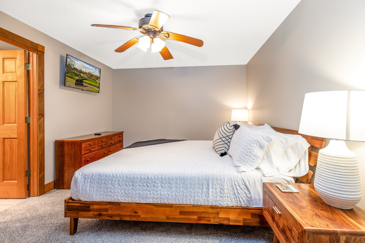 Bedroom 4 featuring a King bed and a Roku Smart TV, and an ensuite bathroom; one of three bedrooms located on the lower level.
