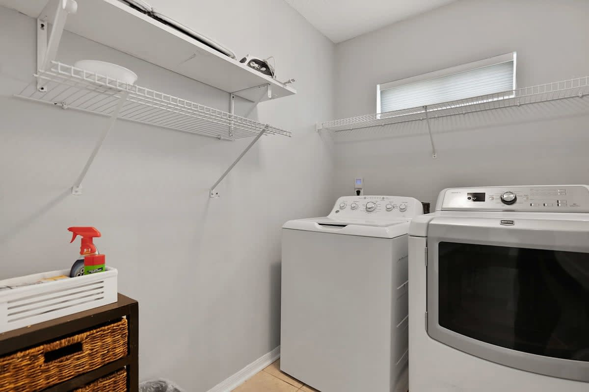 A proper laundry room on the second floor, with washer, dryer, starter pods, dryer sheets and an iron. With a pool, a beach and ten people, this room quietly does more work than any other in the house.