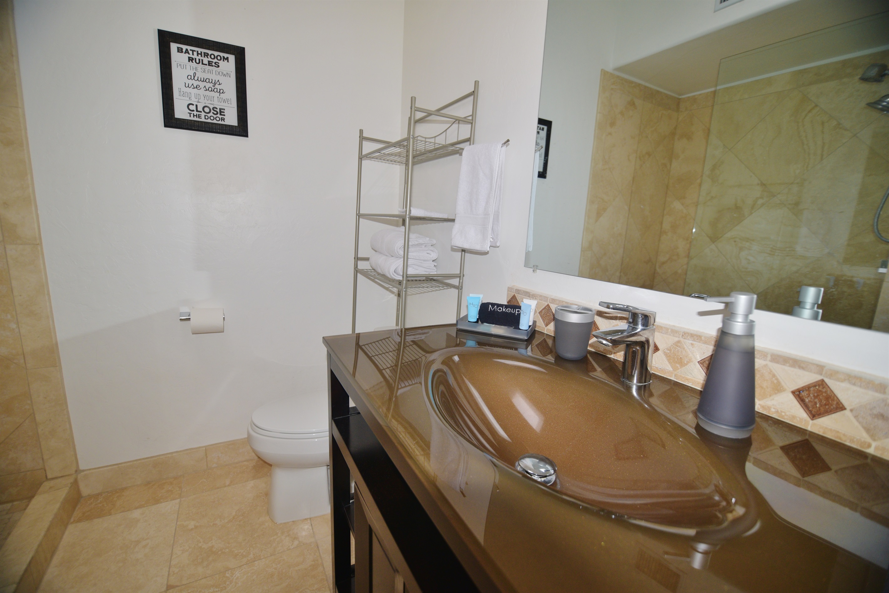 The second bathroom features a custom shower.