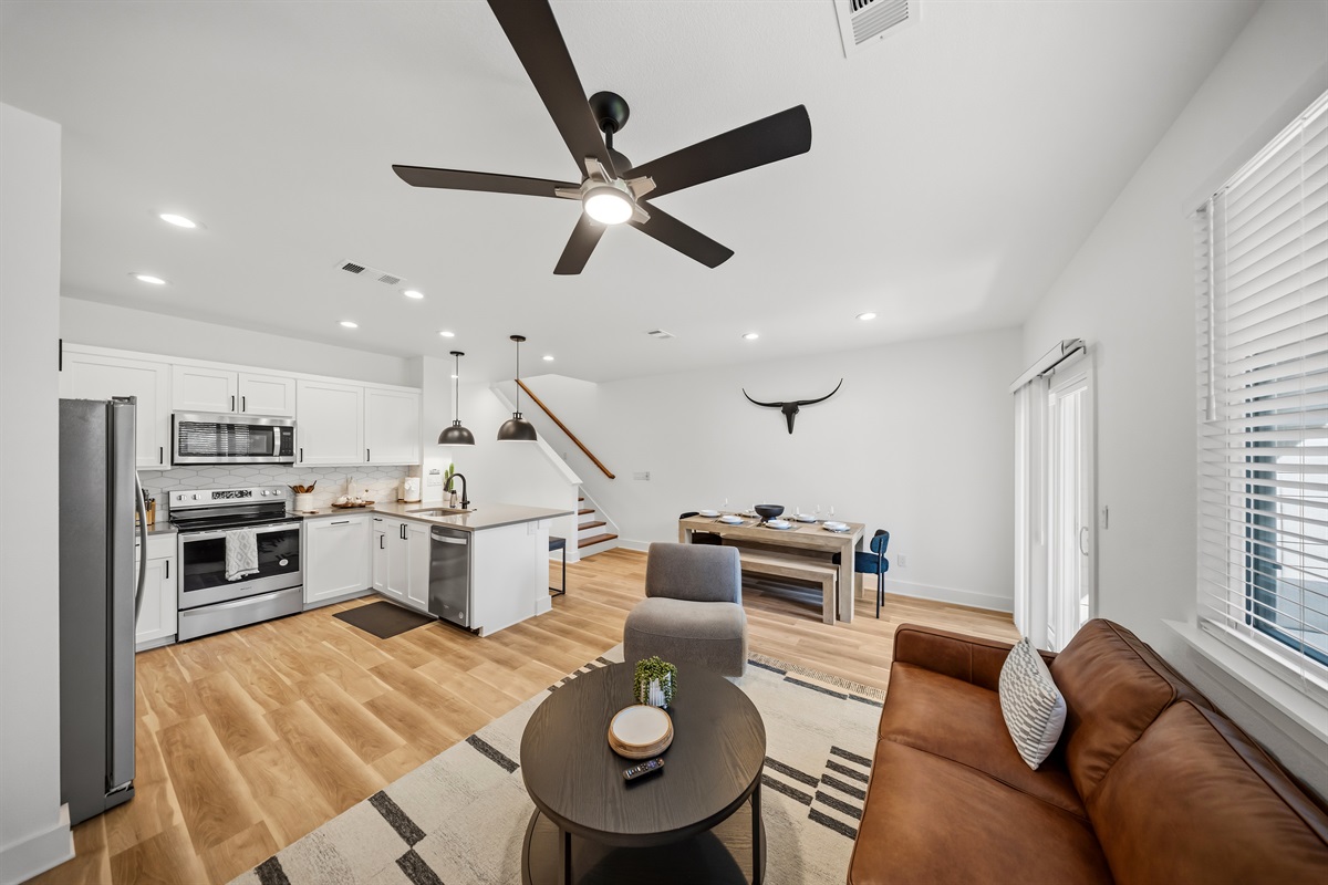 Kitchen and living area designed for easy group gathering with dining space and patio access.