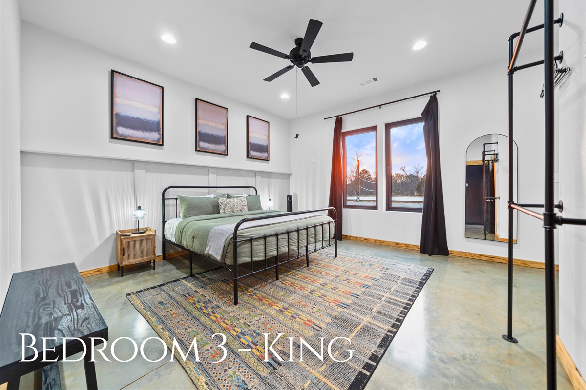 Bedroom 3 continues the comfort theme with a king bed, crisp linens, and an airy layout that feels both bright and restful.