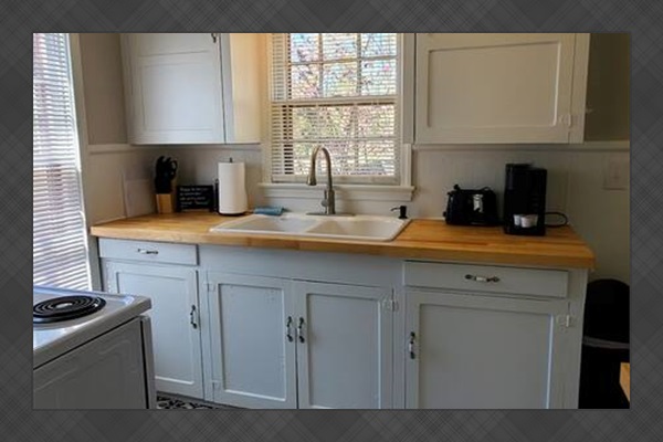 Bright, fully stocked kitchen with essentials including a stove, toaster, knives, and cutting boards. Perfect for cooking meals or prepping quick snacks during your stay.