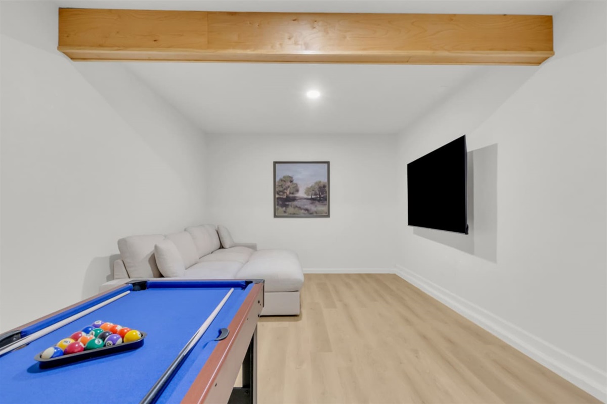 Dedicated entertainment area with large TV, ample seating, and a bright open layout. Ideal for movie nights, lounging, or group downtime.