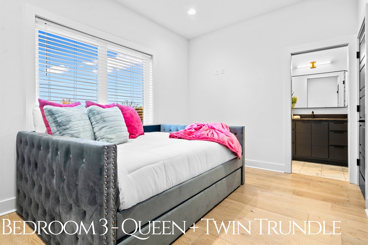 A versatile queen bedroom with a twin trundle, blending cheerful decor and a cozy layout that&rsquo;s perfect for families or small groups.