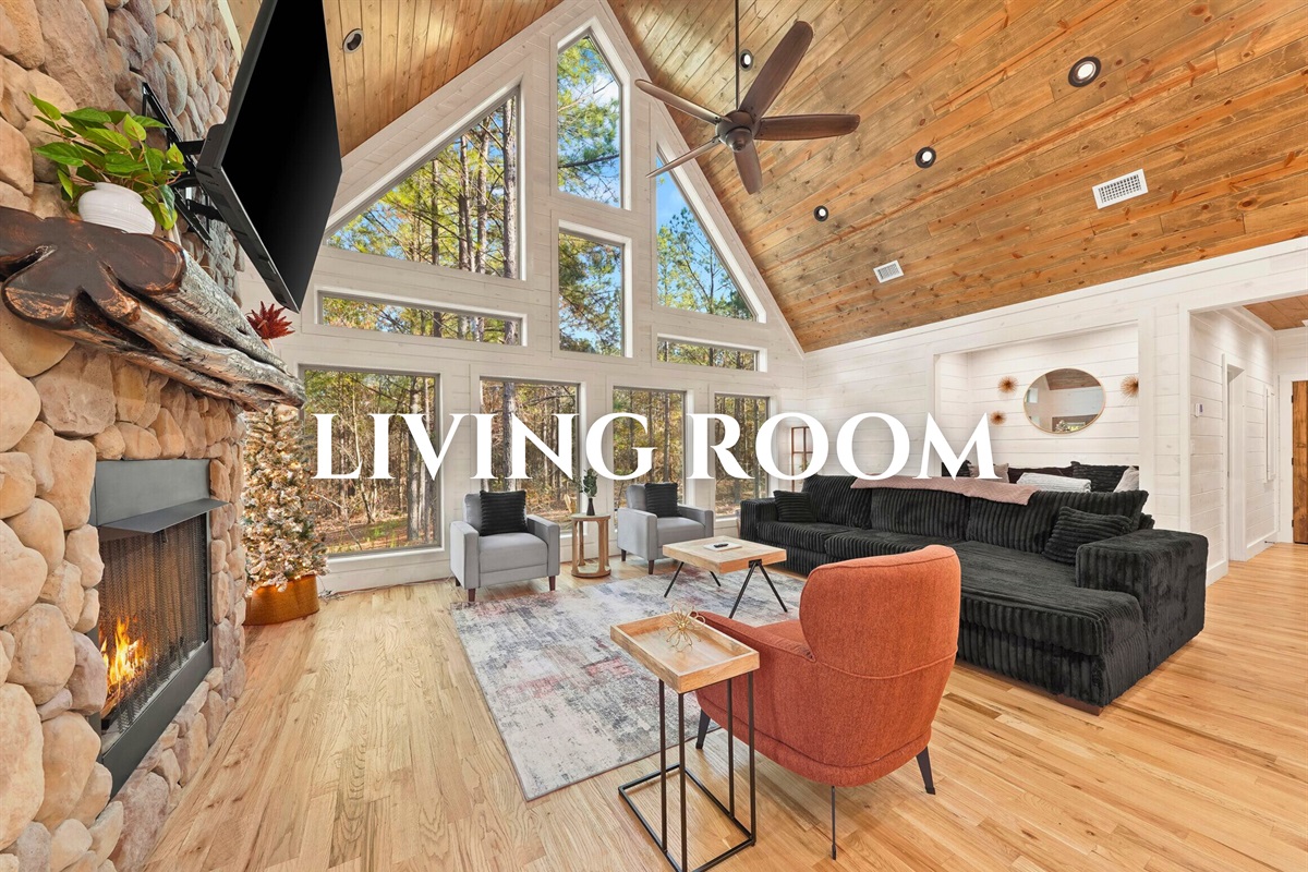 Living room with high ceilings, dining space, and warm tones.