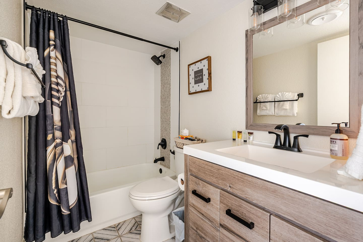 Resort like amenities including shampoo, conditioner, soap, body wash, body lotion, Q-Tips, hair dryer, and makeup remover cloths.