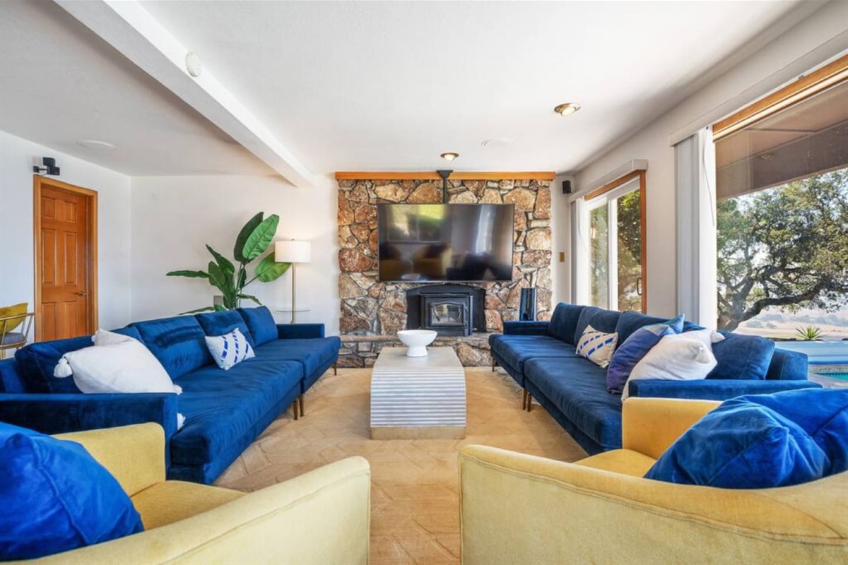 75" 4k TV with several streaming services. Double-wide sectional couches and two swivel chairs easily seats 10 people.