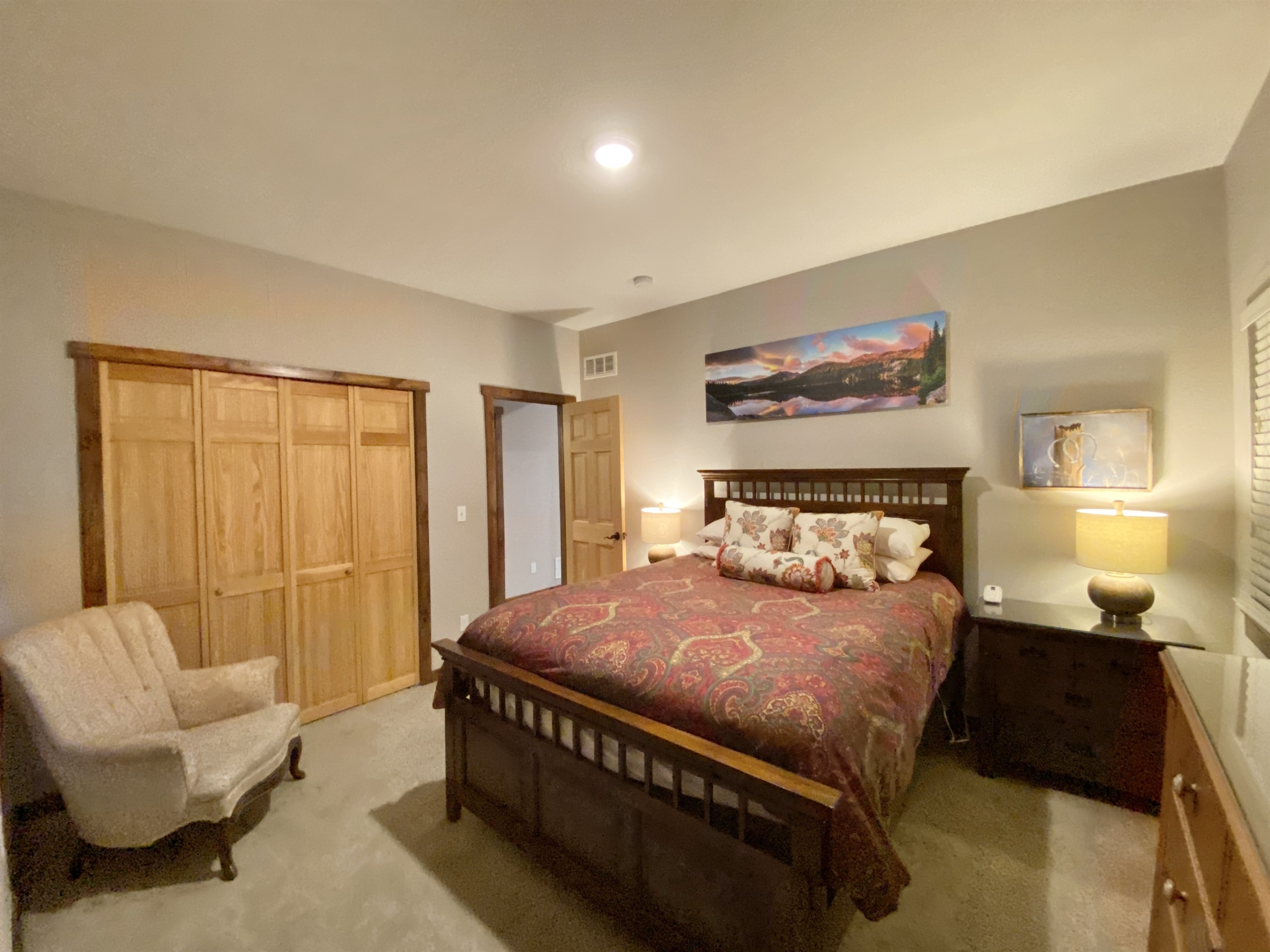Downstairs Bedroom 5 with queen bed with bathroom across the hall