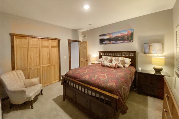 Downstairs Bedroom 5 with queen bed with bathroom across the hall