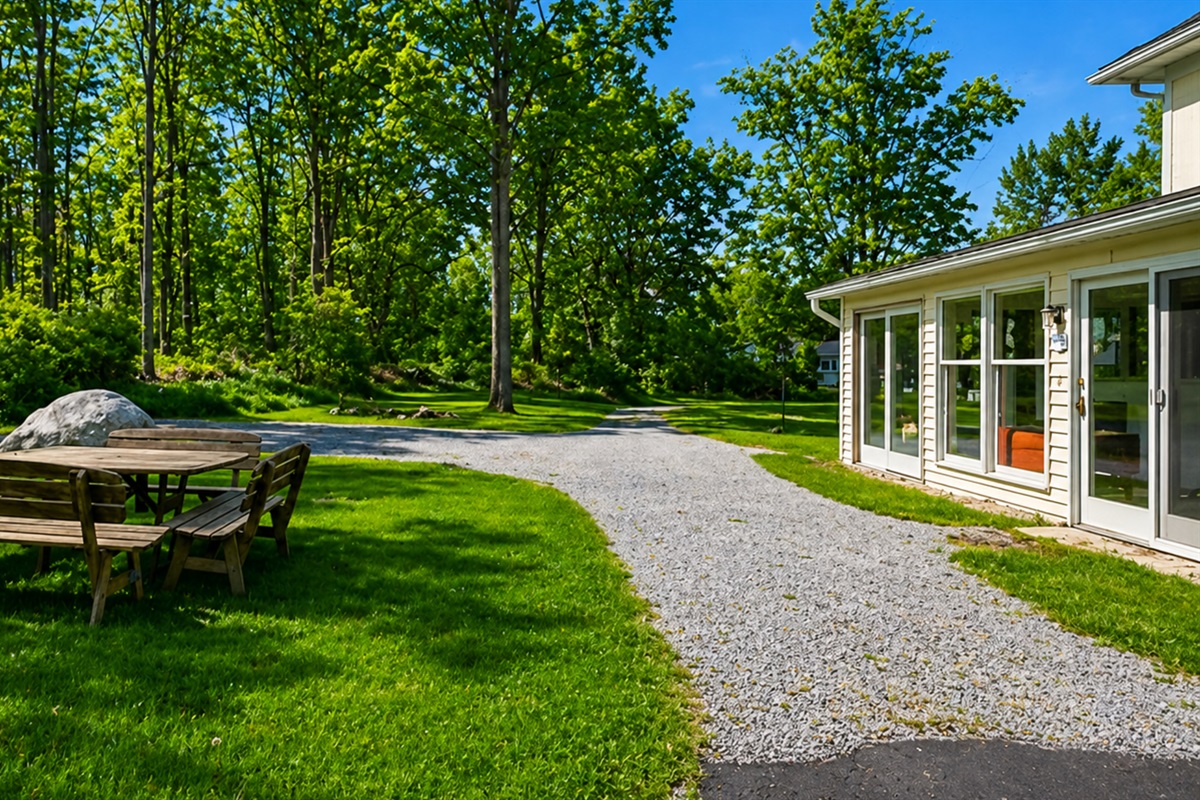 Gather with friends in the backyard surrounded by serene woods and open green space 🍃👨‍👩‍👧‍👦
