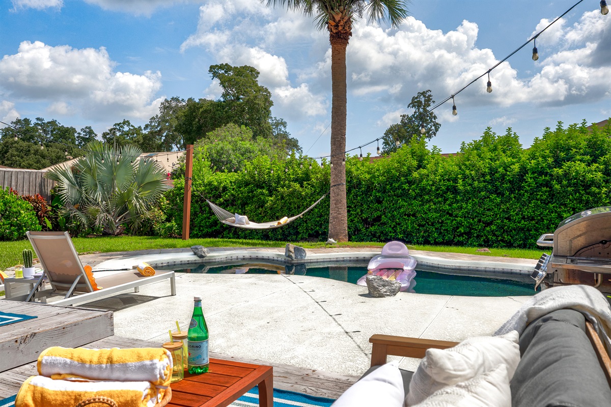 Soak up the sun poolside by swaying in the hammock under the palms