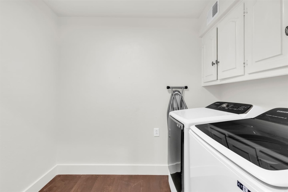 Utility room equipped with an iron and ironing board, offering added convenience for keeping clothes crisp and ready during your stay.