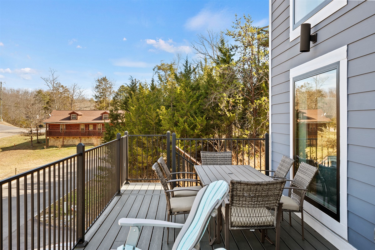Another view of the deck showing ample seating and a relaxed setting for outdoor dining or unwinding.