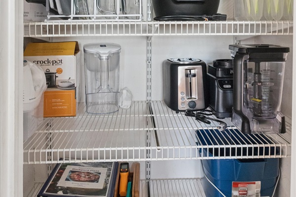 Our South Bend pantry is weekend-ready—stocked with toaster, blender, crockpot, baking dishes, Instant Pot, griddle, containers, serving platters, and pizza oven essentials.
