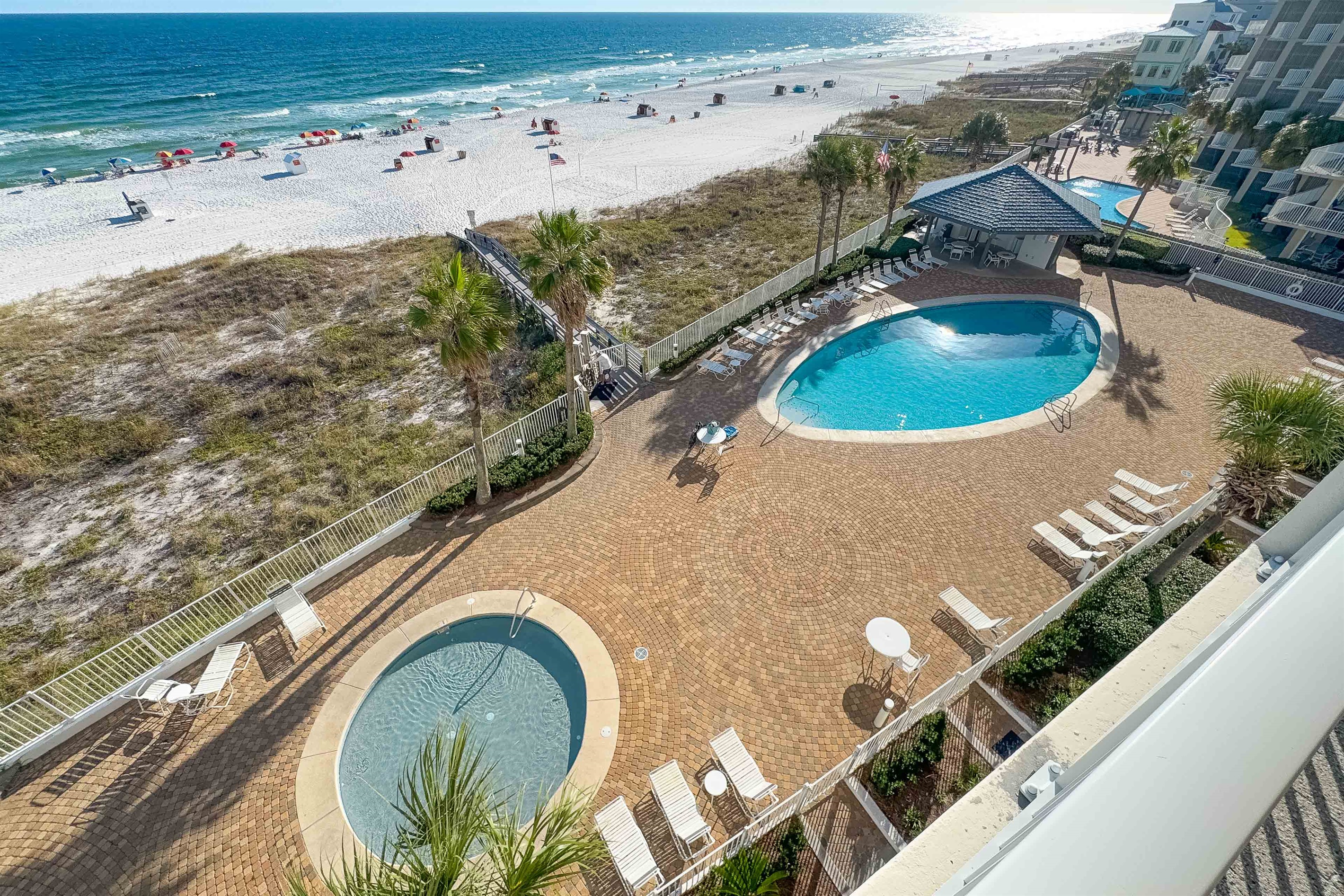 Savor the best of outdoor living with a beautifully designed courtyard, inviting pools, and immediate access to the stunning coastline. An idyllic setting for relaxation.