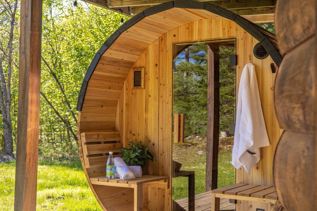 Unwind and recharge in the outdoor barrel sauna nestled among the trees.