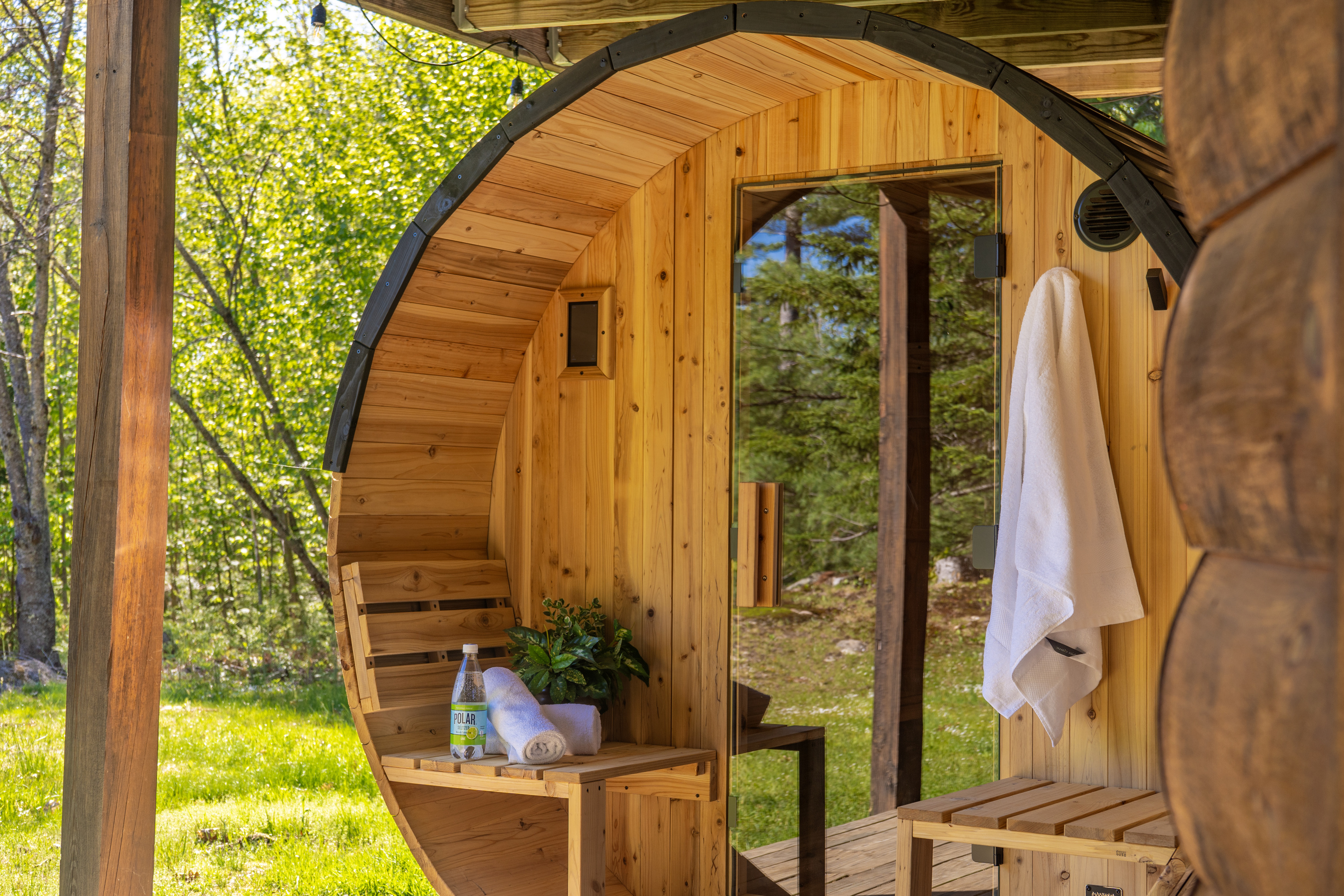 Unwind and recharge in the outdoor barrel sauna nestled among the trees.