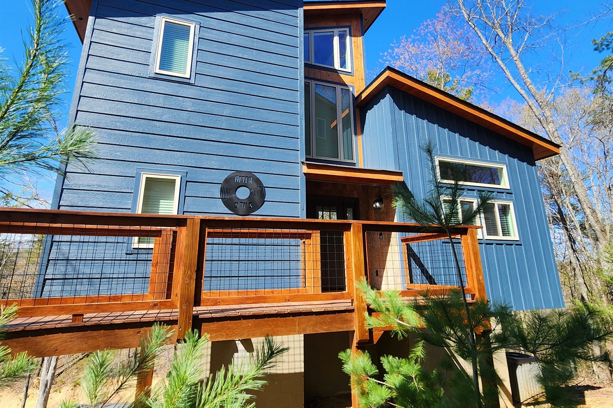 Blue treehouse-style cabin built August 2025 - in-town location with easy road access, no white-knuckle mountain switchbacks or nerve-wracking drives. Walk up and check in.