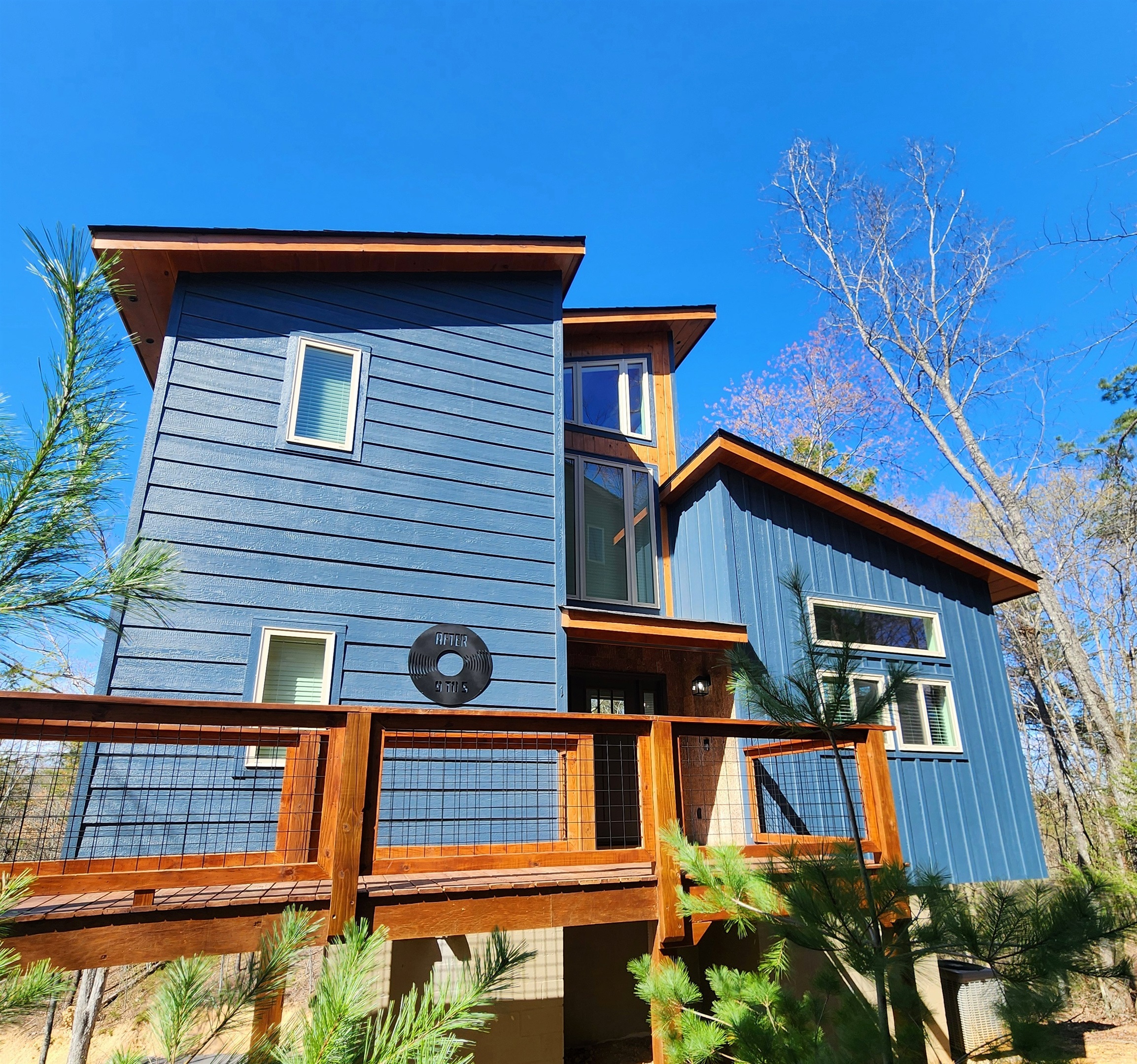 Blue treehouse-style cabin built August 2025 - in-town location with easy road access, no white-knuckle mountain switchbacks or nerve-wracking drives. Walk up and check in.