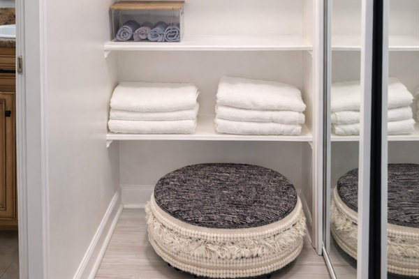 Thoughtfully organized linen closet with plush towels