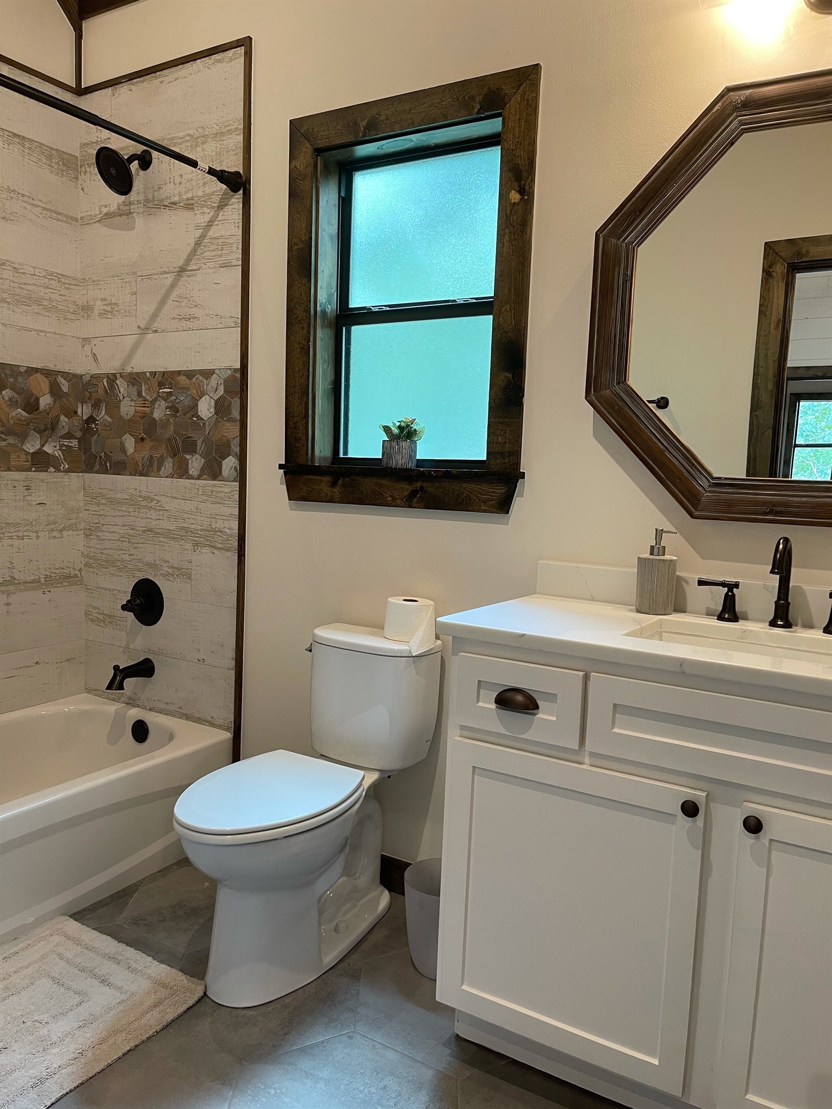 The upstairs bathroom contains a large vanity with plenty of counter space as well as lots of storage behind the cabinet doors.