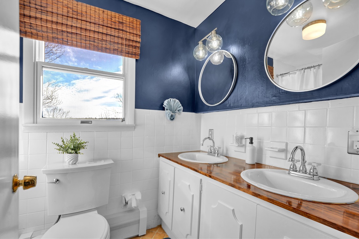 Upstairs bath — fresh, bright, and modern.